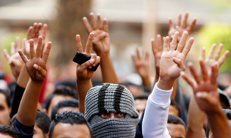 Cairo University students shout slogans against the government and flash the &#039;V&#039; and Rabaa signs after the verdict of former Egyptian President Hosni Mubarak&#039;s trial, at the university&#039;s campus in Giza
