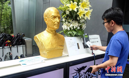 A golden bust of Steve Jobs displayed at a Shanghai Company