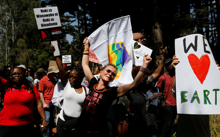 Demonstrators chant slogans and hold banners in protest against U.S. President Donald Trump&#039;s during the Women&#039;s March inside Karura forest in Kenya&#039;s capital Nairobi.