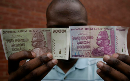 A man holds up newly issued 200 million and 500 million Zimbabwe dollar notes in the capital Harare December 12, 2008. Zimbabwe&#039;s central bank on December 4, 2008 injected 80 trillion Zimbabwe dollars ($8 million) in new bank notes into the economy in a bid to end cash shortages that have seen hordes besieging banks amid a deepening economic crisis. REUTERS/Philimon Bulawayo (ZIMBABWE) - RTR22IKG