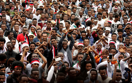 Demonstrators chant slogans while flashing the Oromo protest gesture during celebrations for Irreecha, the thanksgiving festival of the Oromo people, in Bishoftu town, Oromia region, Ethiopia, October 1, 2017.