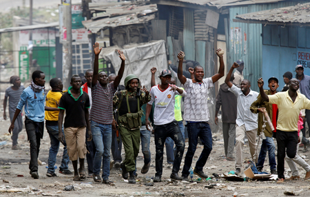 Protesters supporting opposition leader Raila Odinga attempt to make peace with policemen in Mathare, in Nairobi, Kenya