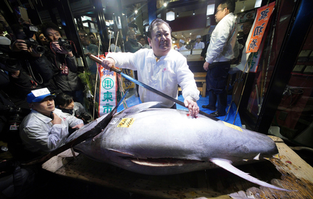 Mandatory Credit: Photo by Eugene Hoshiko/AP/REX/Shutterstock (9307710l) Kiyoshi Kimura, center, president of Kiyomura Co., poses with the bluefin tuna he bought at the annual New Year auction, at his Sushi Zanmai restaurant near Tsukiji fish market in Tokyo early . This year&#039;s top per kilogram price, for a smaller tuna, was $1,419 per kilogram, compared with about $7,930 per kilogram for the 2013 record-setting auction price, the Nihon Keizai Shimbun and other local media reported. That price was paid by Kiyomura Corp., whose owner Kimura runs the Sushi Zanmai chain, the reports said. Kimura has often won the annual auction in the past Tuna Auction, Tokyo, Japan - 05 Jan 2018