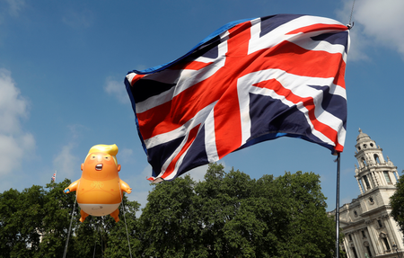 Demonstrators float a blimp portraying U.S. President Donald Trump, next to a Union Flag above Parliament Square, during the visit by Trump and First Lady Melania Trump in London