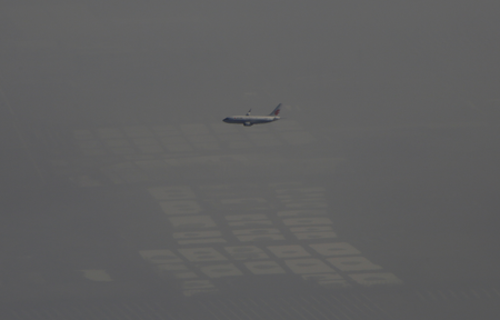 An Air China passenger aircraft flies amid heavy smog over the suburb of Beijing, China on Jan.2, 2017. REUTERS/Jason Lee