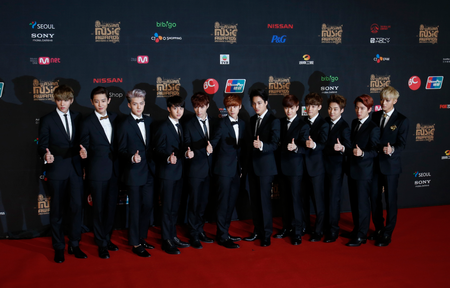 Members of South Korea K-pop group Exo pose on the red carpet during the Mnet Asian Music Awards in Hong Kong November 22, 2013.