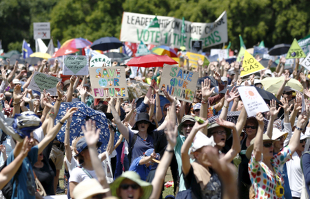 Protesters raise their hands in Sydney, Australia.