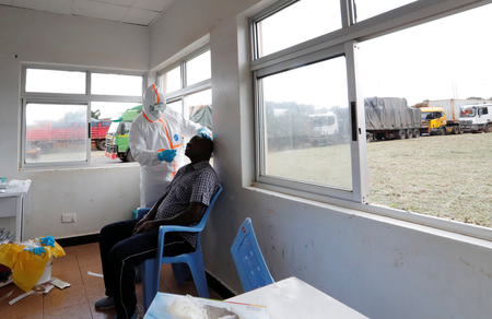 A Kenyan ministry of health medical worker tests a truck driver for Covid-19 on May 12.