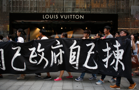 Protesters carry a banner which reads &quot;We choose our own government&quot; during a march at the financial Central district in Hong Kong September 24, 2014.
