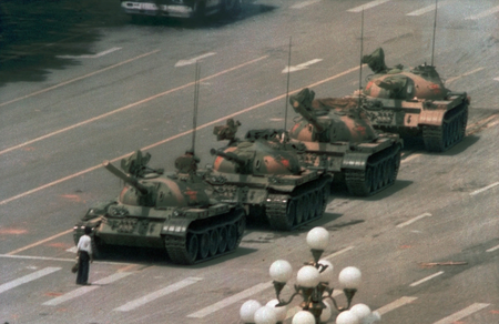 A Chinese man stands alone to block a line of tanks heading east on Beijing&#039;s Cangan Blvd. in Tiananmen Square on June 5, 1989. The man, calling for an end to the recent violence and bloodshed against pro-democracy demonstrators, was pulled away by bystanders, and the tanks continued on their way. The Chinese government crushed a student-led demonstration for democratic reform and against government corruption, killing hundreds, or perhaps thousands of demonstrators in the strongest anti-government protest since the 1949 revolution. Ironically, the name Tiananmen means &quot;Gate of Heavenly Peace&quot;. (AP Photo/Jeff Widener)