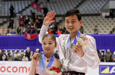 Bronze medalists Ryom Tae Ok and Kim Ju Sik of North Korea pose for photographers during the victory ceremony of the Pairs event of Figure Skating competition at Makomanai Indoor Skating Rink at the Asian Winter Games in Sapporo, northern Japan, Saturday, Feb. 25, 2017.