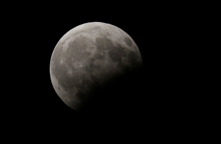 The rising moon is seen during a partial lunar eclipse over Beirut, Lebanon.