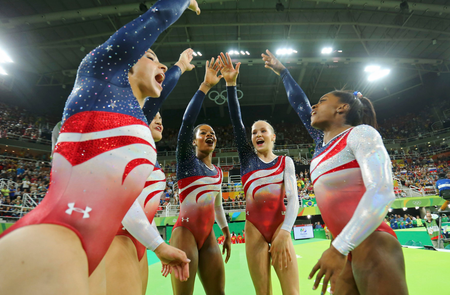 2016 Rio Olympics - Artistic Gymnastics - Final - Women&#039;s Team Final - Rio Olympic Arena - Rio de Janeiro, Brazil - 09/08/2016. (L-R) Alexandra Raisman (USA) of USA (Aly Raisman), Laurie Hernandez (USA) of USA, Gabrielle Douglas (USA) of USA (Gabby Douglas), Madison Kocian (USA) of USA and Simone Biles (USA) of USA celebrate winning gold in the women&#039;s team final. REUTERS/Mike Blake FOR EDITORIAL USE ONLY. NOT FOR SALE FOR MARKETING OR ADVERTISING CAMPAIGNS. - RTSM8BI