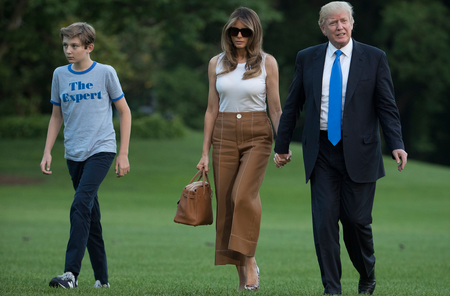 President Donald Trump, first lady Melania Trump, and their son and Barron Trump walk from Marine One across the South Lawn to the White House in Washington, Sunday, June 11, 2017, as they return from Bedminster, N.J. (AP Photo/Carolyn Kaster)