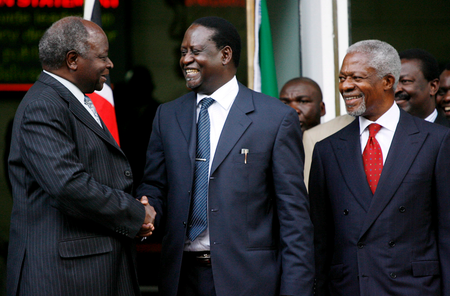 Kenyan President Mwai Kibaki (L) shakes hands with opposition leader Raila Odinga (C) while former UN Secretary General Kofi Annan (R looks on shortly after signing a contentious power sharing deal on 28 February 2008. Kenya&#039;s rival leaders signed a power-sharing deal mediated by Kofi Annan to end the country&#039;s post-election crisis which killed over 1500 people and left 600,000 displaced.