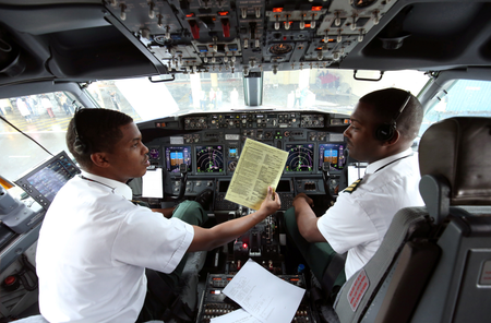 Pilots sit in the cockpit as they prepare the Ethiopian Airlines ET314 flight to Eritrea&#039;s capital Asmara at the Bole International Airport in Addis Ababa, Ethiopia July 18, 2018.