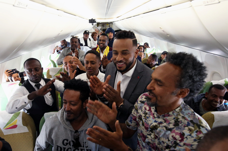 Passengers sing and dance inside an Ethiopian Airlines flight to Asmara international airport in Asmara, Eritrea July 18, 2018.