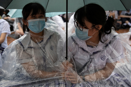 Two schoolgirls participate in a boycott of their classes in protest against the government in Hong Kong on September 2, 2019