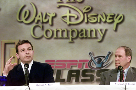 Robert A. Iger, (L) president and CEO of The Walt Disney Company, gives details of the purchase of Fox Family Worldwide as Michael Eisner, chairman and CEO of The Walt Disney Company