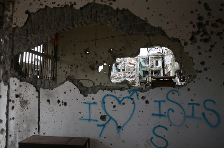 A graffiti that reads &quot;I love ISIS&quot; is seen in a damaged building in Marawi city, Philippines, October 25, 2017.