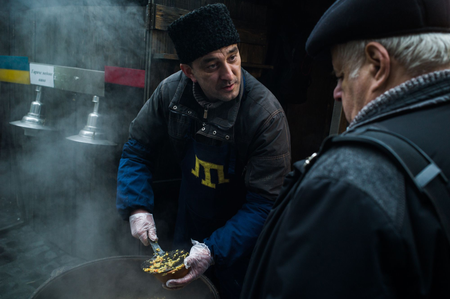 Yashar, a high-school French teacher from Crimea who now sells home-made food in the Lviv market.