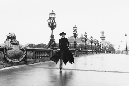 Model Chantal Dumont crosses the Alexandre III bridge in Paris.