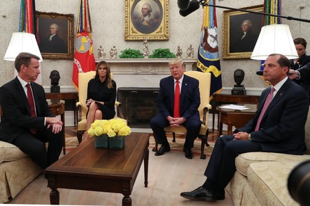 U.S. President Donald Trump speaks about banning non-tobacco flavored vaping products next to first lady Melania Trump as Health and Human Services (HHS) Secretary Alex Azar (R) and Acting Food and Drug Administration (FDA) Administrator Norman &quot;Ned&quot; Sharpless listen in the Oval Office of the White House in Washington, U.S., September 11, 2019.