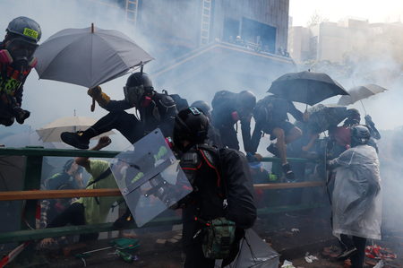 Protesters attempt to escape from tear gas while trying to leave the campus of Hong Kong Polytechnic University (PolyU) during clashes with police in Hong Kong, China November 18, 2019.
