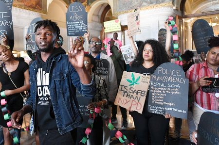 Jawnanza James Williams of VOCAL NY, left, speaks with a coalition of protesters urging legislators to pass legalization of marijuana legislation at the state Capitol Wednesday, June 19, 2019, in Albany, N.Y. A push to legalize recreational marijuana in New York state has failed after state leaders did not reach a consensus on several key details in the final days of the legislative session. (AP Photo/Hans Pennink)