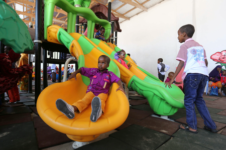 Children play in celebration after attending Eid al-Fitr prayers to mark the end of the fasting month of Ramadan in Somalia&#039;s capital Mogadishu, July 28, 2014.