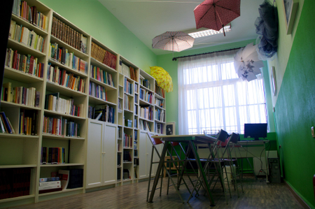 At Manolis Andronikos Gymnasio, a 100-student elementary school in Vergina, teachers have hung umbrellas from the ceiling to bring color to their very small library.