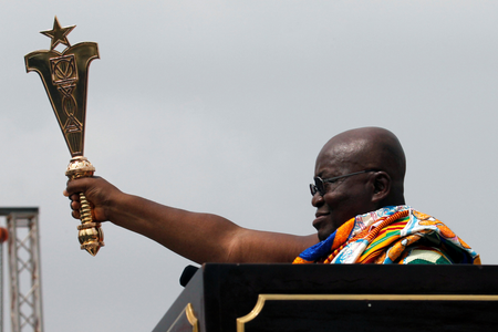 Ghana&#039;s new President Nana Akufo-Addo lifts up a staff of office during the swearing-in ceremony at Independence Square in Accra, Ghana. The West African nation also celebrated 60 years since independence.