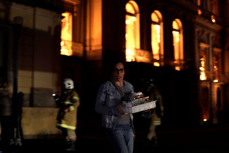A worker rescues items during a fire at the National Museum of Brazil in Rio de Janeiro, Brazil September 2, 2018. - RC1AC83B67C0