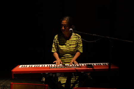 Composer Keiko Fujiie plays the keyboard during a rehearsal for the premiere of the second act of Là-bas ou Ici at the Institut Français in Ouagadougou, Burkina Faso in March.