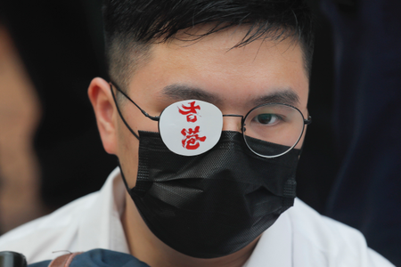 A secondary student covers one eye reading &quot;Hong Kong&quot; in memory of a woman injured in an earlier pro-democracy protest in Hong Kong, on Monday, Sept. 2, 2019.