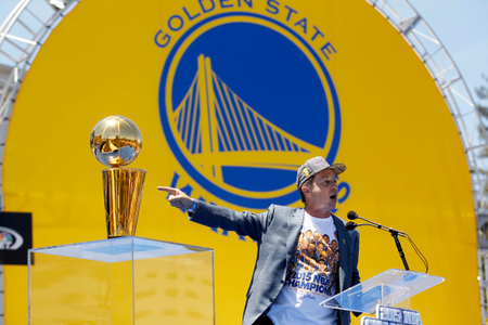 Jun 19, 2015; Oakland, CA, USA; Co-executive chairman and CEO Joe Lacob points towards the Larry O&#039;Brien trophy during the Golden State Warriors 2015 championship celebration in downtown Oakland.