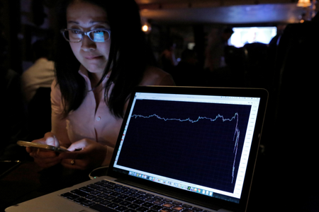 A woman watching the Brexit vote in The Churchill Tavern, a British themed pub, reacts as a graph shows the British Pound falling in value following the announcement that Britain would leave the European Union, in the Manhattan, New York on June 23. (Reuters/Andrew Kelly)