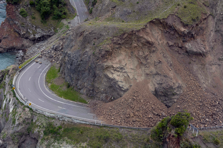 A landslide covers a section of state highway 1 near Kaikoura, New Zealand, Monday, Nov. 14, 2016, after a powerful earthquake. A powerful earthquake that rocked New Zealand on Monday triggered landslides and a small tsunami, cracked apart roads and homes, but largely spared the country the devastation it saw five years ago when a deadly earthquake struck the same region.