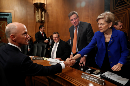 Richard Smith, former chairman and CEO of Equifax, Inc., greets Sen. Elizabeth Warren (D-MA) prior to testifying before the U.S. Senate Banking Committee on Capitol Hill in Washington, U.S., October 4, 2017. REUTERS/Aaron P. Bernstein - RC1DB1A00A20