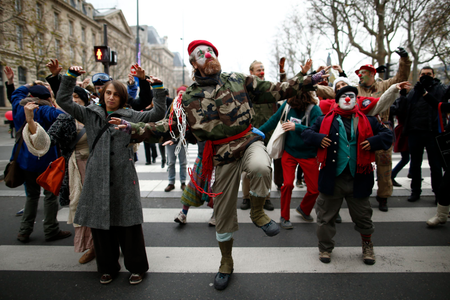 Environmentalists dance during a protest near the Place de la Republique.
