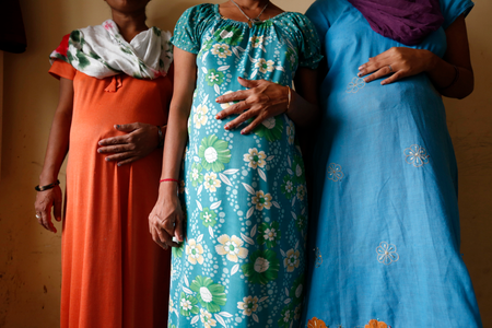 Surrogate mothers pose for a photograph inside a temporary home for surrogates provided by Akanksha IVF centre in Anand town