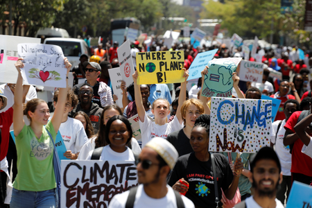 Environmental activists march carrying signs as they take part in the Climate strike protest calling for action on climate change, in Nairobi, Kenya, September 20, 2019.