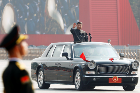Chinese president Xi Jinping waves from a vehicle as he reviews the troops at the parade marking the 70th founding anniversary of the People&#039;s Republic of China in Beijing, China October 1, 2019.