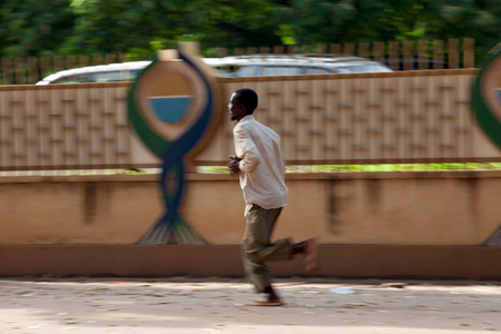 A man runs after hearing gunfire in Ouagadougou.
