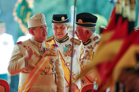 Sultan Muhammad V, left, chats with Malaysian Prime Minister Najib Razak, right, and Deputy Prime Minister Ahmad Zahid Hamidi, center, after his welcoming ceremony at the Parliament House in Kuala Lumpur, Malaysia, Tuesday, Dec. 13, 2016. Sultan Muhammad V of Kelantan will serve a five-year term as King of Malaysia from Tuesday. (AP Photo/Vincent Thian)