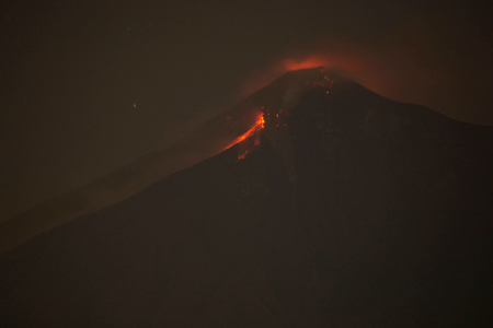 In this image taken with a long exposure, the Volcan de Fuego, or Volcano of Fire, spews hot molten rock from its crater in Alotenango, Guatemala, Sunday, June 3, 2018. Rescuers struggled to reach rural residents cut off by the deadly volcanic eruption Sunday. (AP Photo/Luis Soto)