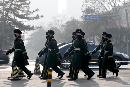 Chinese paramilitary policemen wearing masks for protection against pollution march as the capital city is shrouded by smog in Beijing, Monday, Dec. 19, 2016. Chinese cities are limiting the number of cars on roads and have temporarily shut down factories to cut down pollution during a national &quot;red alert&quot; for smog. (AP Photo/Andy Wong)