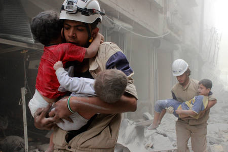 Members of the Civil Defence rescue children after what activists said was an air strike by forces loyal to Syria&#039;s President Bashar al-Assad in al-Shaar neighbourhood of Aleppo June 2, 2014.