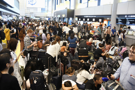 Passengers are stranded after railways and subway operators suspended their services due to Typhoon Faxai, at Narita airport on Sept. 9.