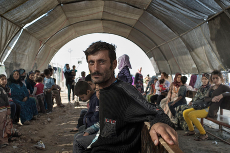 People waiting at Domiz refugee camp